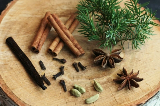 an assortment of spices sitting on top of a wooden cutting board